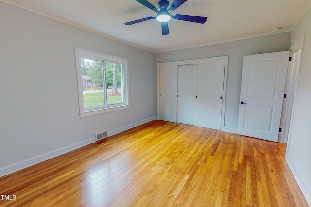 303 Winhaven St, Roxboro, NC 27573 - unfurnished bedroom featuring ornamental molding, light wood-style floors, a closet, and ceiling fan