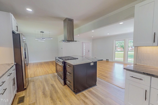303 Winhaven St, Roxboro, NC 27573 - kitchen with island range hood, stainless steel appliances, light wood-style floors, white cabinets, and light stone countertops