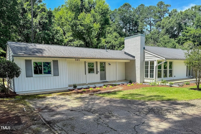303 Winhaven St, Roxboro, NC 27573 - view of front facade with a chimney and a shingled roof