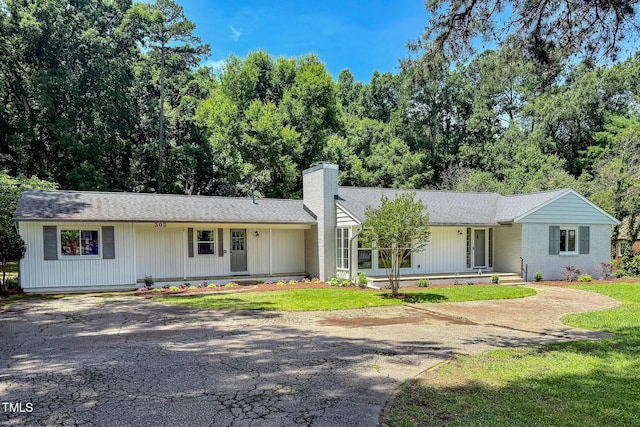 303 Winhaven St, Roxboro, NC 27573 - ranch-style house featuring a chimney, driveway, and roof with shingles