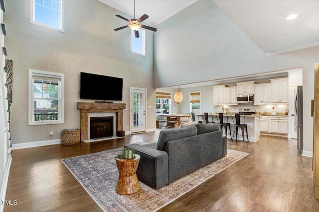 52 Summit Overlook Dr, Clayton, NC 27527 - living room featuring crown molding, high vaulted ceiling, ceiling fan, healthy amount of natural light, and dark wood-type flooring
