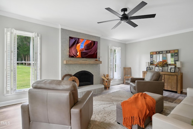 633 Fleming Rd, Youngsville, NC 27596 - living room featuring ornamental molding, wood finished floors, plenty of natural light, a ceiling fan, and a brick fireplace