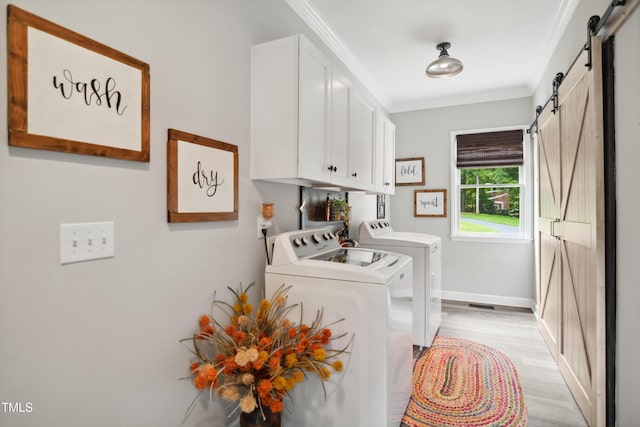 633 Fleming Rd, Youngsville, NC 27596 - washroom featuring a barn door, cabinet space, washer and clothes dryer, crown molding, and light wood-style flooring