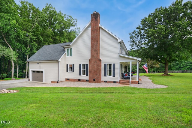633 Fleming Rd, Youngsville, NC 27596 - back of house with crawl space, covered porch, a garage, a chimney, and a lawn
