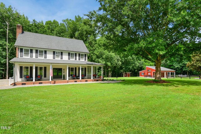 633 Fleming Rd, Youngsville, NC 27596 - view of front facade with a porch, a chimney, a shingled roof, view of scattered trees, and french doors
