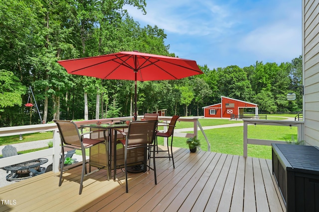633 Fleming Rd, Youngsville, NC 27596 - wooden deck featuring a lawn, an outbuilding, view of scattered trees, and outdoor dining area
