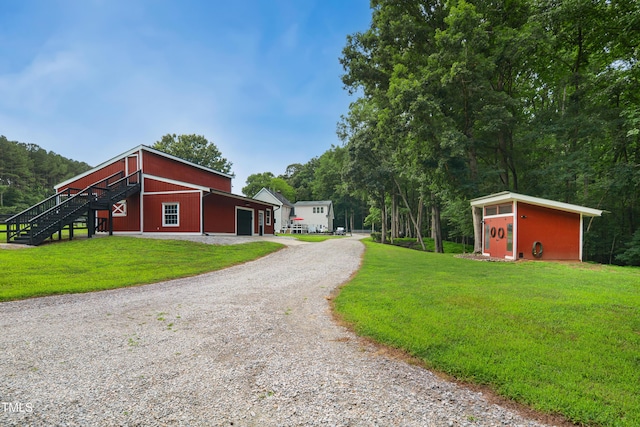 633 Fleming Rd, Youngsville, NC 27596 - view of home's exterior featuring an outbuilding, a yard, and gravel driveway