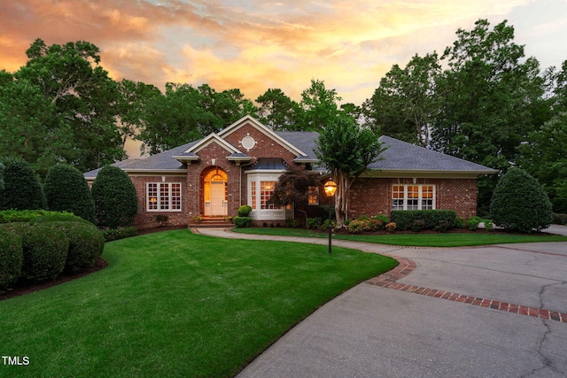 114 Kendleton Pl, Cary, NC 27518 - view of front facade with brick siding and a front lawn