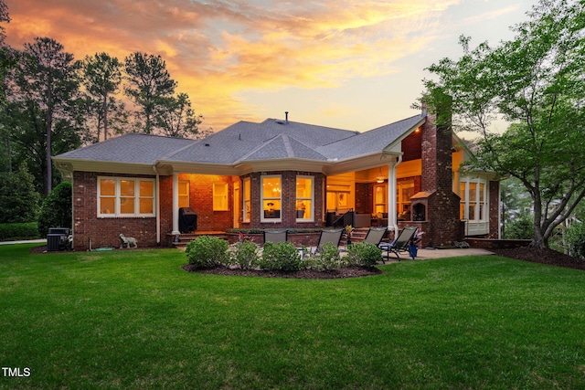 114 Kendleton Pl, Cary, NC 27518 - back of property featuring brick siding, a chimney, a patio, and a yard