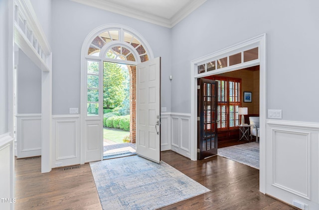114 Kendleton Pl, Cary, NC 27518 - foyer with a decorative wall, ornamental molding, wood finished floors, and wainscoting