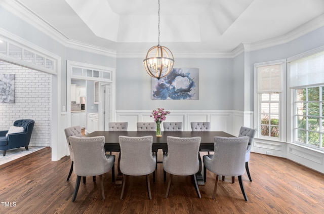 114 Kendleton Pl, Cary, NC 27518 - dining room featuring a chandelier, a raised ceiling, dark wood-type flooring, a decorative wall, and a wainscoted wall