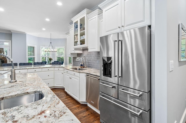 114 Kendleton Pl, Cary, NC 27518 - kitchen featuring stainless steel appliances, glass insert cabinets, dark wood-style flooring, white cabinetry, and tasteful backsplash