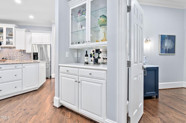 114 Kendleton Pl, Cary, NC 27518 - indoor dry bar with crown molding, high end fridge, dark wood finished floors, decorative backsplash, and recessed lighting