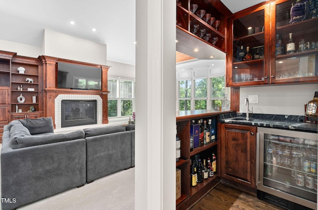 114 Kendleton Pl, Cary, NC 27518 - indoor wet bar featuring wine cooler, a fireplace, and dark wood-style flooring