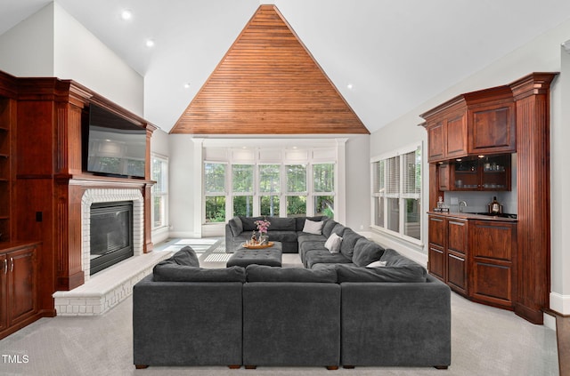 114 Kendleton Pl, Cary, NC 27518 - living area with high vaulted ceiling, a glass covered fireplace, light colored carpet, and recessed lighting
