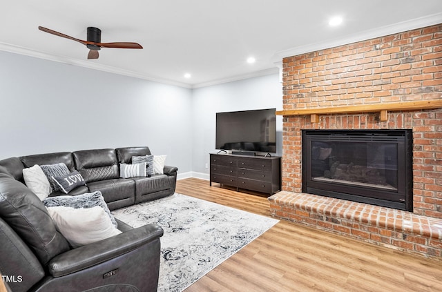 114 Kendleton Pl, Cary, NC 27518 - living room featuring crown molding, wood finished floors, a fireplace, a ceiling fan, and recessed lighting
