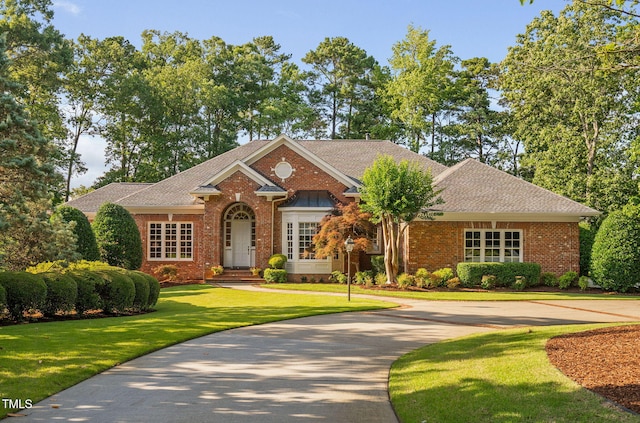 114 Kendleton Pl, Cary, NC 27518 - view of front of home featuring brick siding, a front yard, and a shingled roof