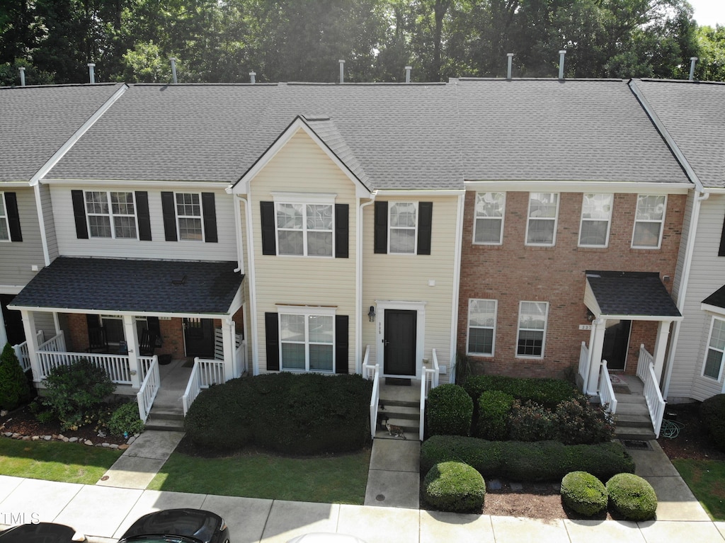 335 Anterbury Dr, Apex, NC 27502 - townhome / multi-family property featuring a porch