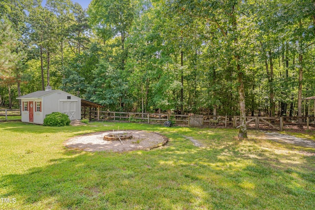 300 Williamston Ridge Dr, Youngsville, NC 27596 - fenced backyard with a fire pit and a storage shed