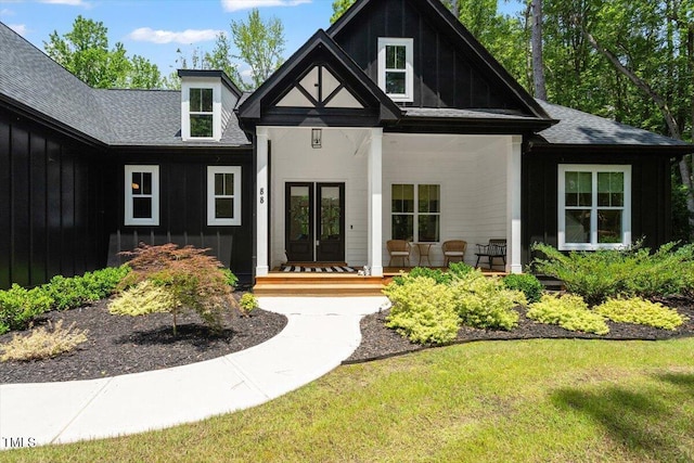 88 Priscilla Ln, Fuquay Varina, NC 27526 - property entrance with a porch, a shingled roof, french doors, and a yard