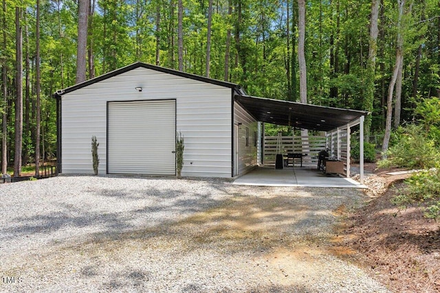 88 Priscilla Ln, Fuquay Varina, NC 27526 - garage with a garage, driveway, and a wooded view