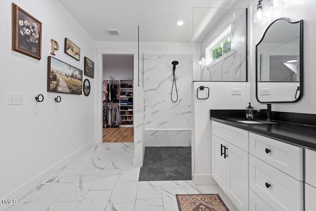 88 Priscilla Ln, Fuquay Varina, NC 27526 - full bath with marble look tiles, vanity, a marble finish shower, a walk in closet, and recessed lighting