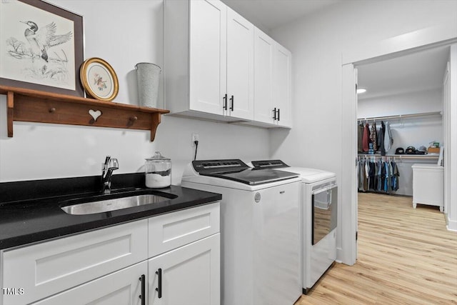 88 Priscilla Ln, Fuquay Varina, NC 27526 - laundry area featuring separate washer and dryer, cabinet space, and light wood-style flooring