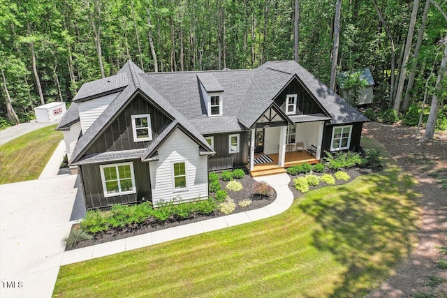 88 Priscilla Ln, Fuquay Varina, NC 27526 - view of front of house featuring covered porch, board and batten siding, roof with shingles, and a front lawn