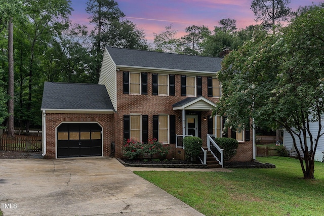 1006 Mingo Pl, Knightdale, NC 27545 - view of front facade featuring an attached garage, roof with shingles, driveway, and brick siding