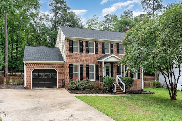 1006 Mingo Pl, Knightdale, NC 27545 - view of front of house with an attached garage, a shingled roof, brick siding, driveway, and a chimney