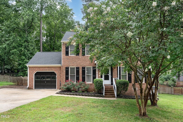 1006 Mingo Pl, Knightdale, NC 27545 - view of front of house with an attached garage, brick siding, driveway, and roof with shingles