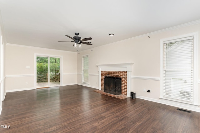1006 Mingo Pl, Knightdale, NC 27545 - unfurnished living room featuring ceiling fan, wood finished floors, a brick fireplace, and ornamental molding
