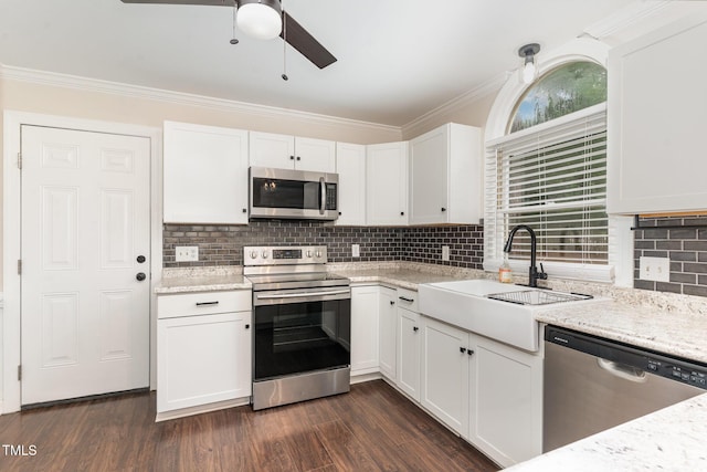 1006 Mingo Pl, Knightdale, NC 27545 - kitchen featuring stainless steel appliances, ceiling fan, white cabinetry, decorative backsplash, and crown molding