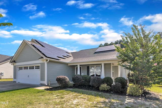 39 All Aboard Cir, Willow Springs, NC 27592 - view of front facade featuring an attached garage, roof mounted solar panels, concrete driveway, a front yard, and roof with shingles
