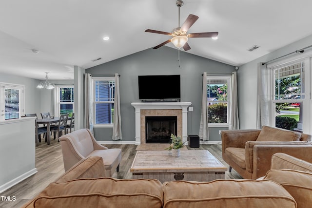 39 All Aboard Cir, Willow Springs, NC 27592 - living area with lofted ceiling, a chandelier, a ceiling fan, wood finished floors, and a fireplace with flush hearth