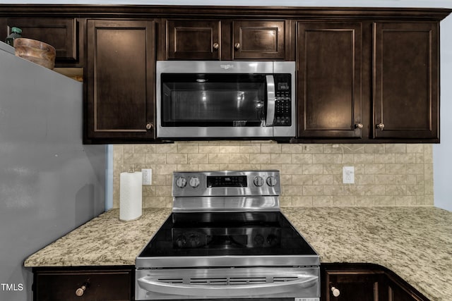39 All Aboard Cir, Willow Springs, NC 27592 - kitchen featuring stainless steel appliances, dark brown cabinets, decorative backsplash, and light stone countertops