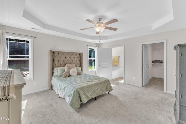 39 All Aboard Cir, Willow Springs, NC 27592 - bedroom with a raised ceiling, light carpet, multiple windows, and ensuite bath