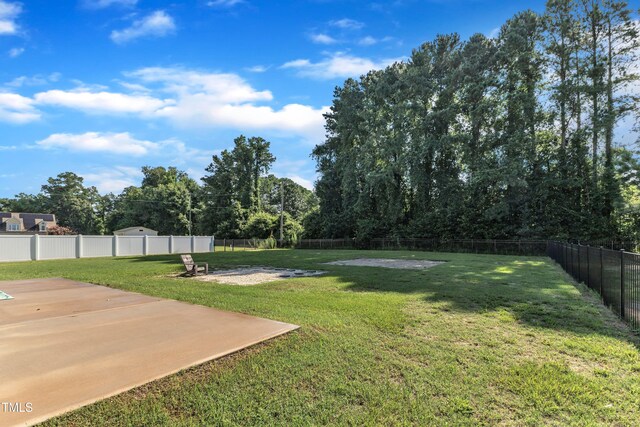 39 All Aboard Cir, Willow Springs, NC 27592 - fenced backyard with a patio area