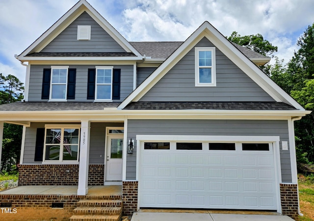 5905 Genesee Dr, Home, Durham, NC 27712 - view of front of home with brick siding, covered porch, a shingled roof, and driveway
