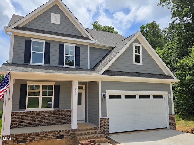 5905 Genesee Dr, Home, Durham, NC 27712 - view of front of house featuring brick siding, driveway, covered porch, and a garage
