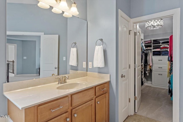 2941 Grandview Heights Ln, Raleigh, NC 27614 - bathroom featuring vanity, a spacious closet, and a chandelier