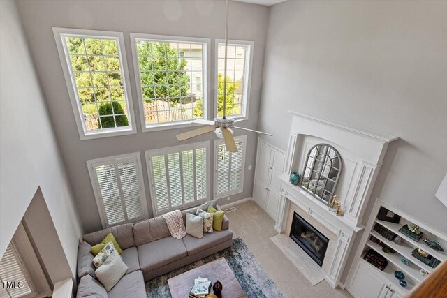 2941 Grandview Heights Ln, Raleigh, NC 27614 - living area with a towering ceiling, ceiling fan, and a fireplace