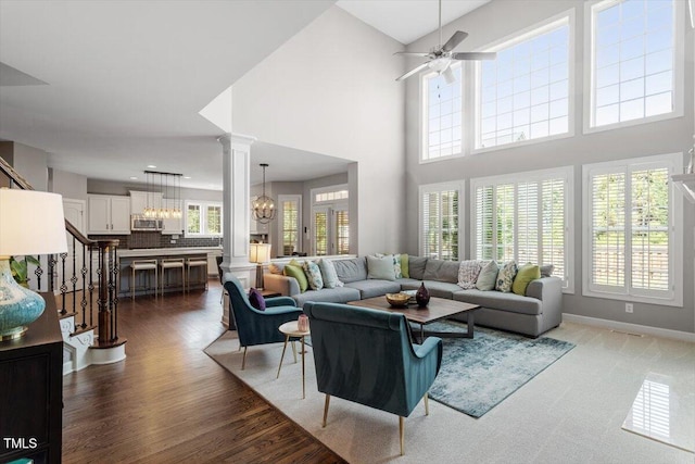 2941 Grandview Heights Ln, Raleigh, NC 27614 - living room with decorative columns, healthy amount of natural light, a chandelier, ceiling fan, and a high ceiling
