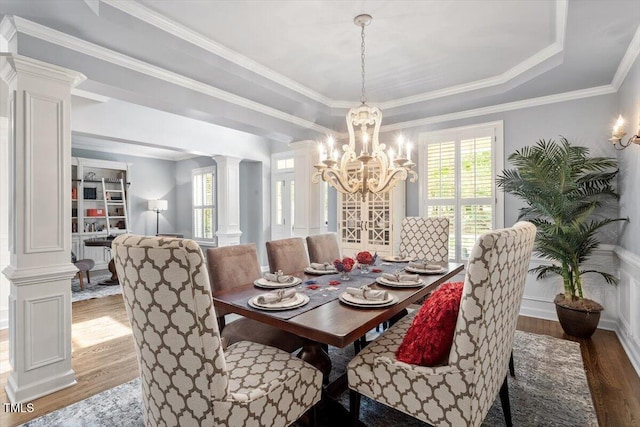 2941 Grandview Heights Ln, Raleigh, NC 27614 - dining space featuring wood finished floors, ornate columns, a chandelier, a raised ceiling, and crown molding