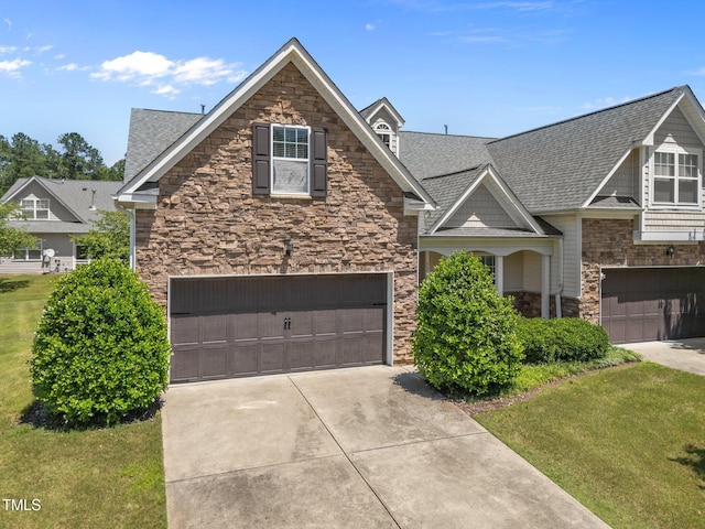 5216 Marcella Ct, Durham, NC 27707 - view of front of home featuring stone siding, a garage, a shingled roof, concrete driveway, and a front lawn