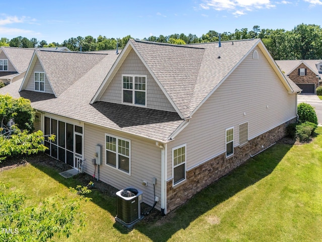 5216 Marcella Ct, Durham, NC 27707 - rear view of property featuring roof with shingles, a lawn, and stone siding