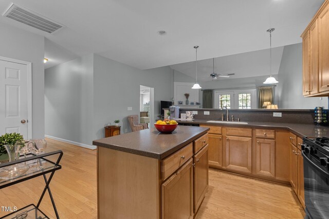 5216 Marcella Ct, Durham, NC 27707 - kitchen with gas stove, dark countertops, light wood finished floors, and a ceiling fan