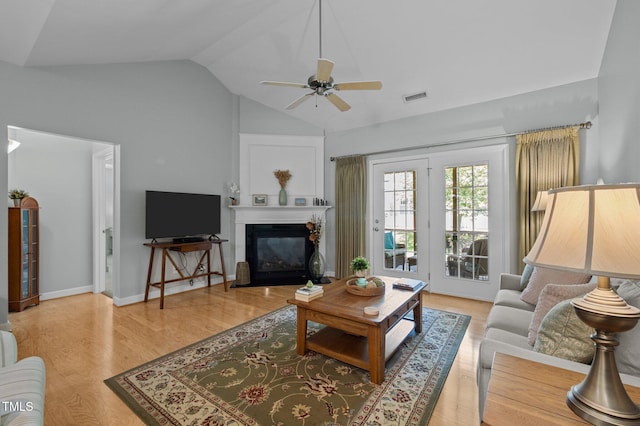 5216 Marcella Ct, Durham, NC 27707 - living area with vaulted ceiling, ceiling fan, a glass covered fireplace, and light wood-style floors