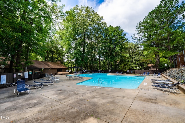 113 Twisted Oak Pl, Durham, NC 27705 - community pool featuring a patio and view of wooded area