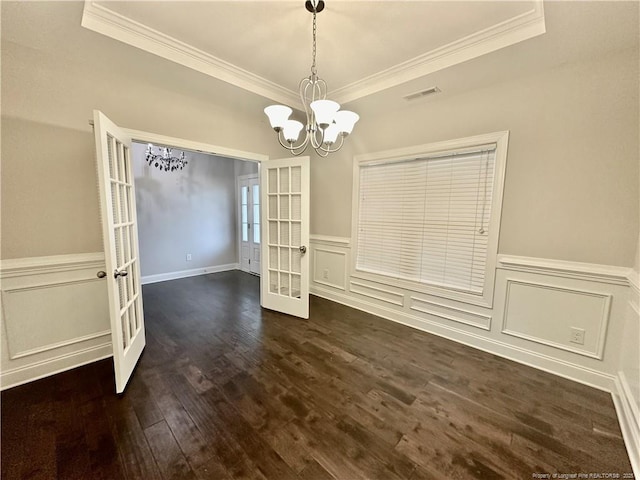 3014 Eaglecrest Ln, Fayetteville, NC 28306 - unfurnished dining area with french doors, crown molding, a chandelier, dark wood-style flooring, and a wainscoted wall